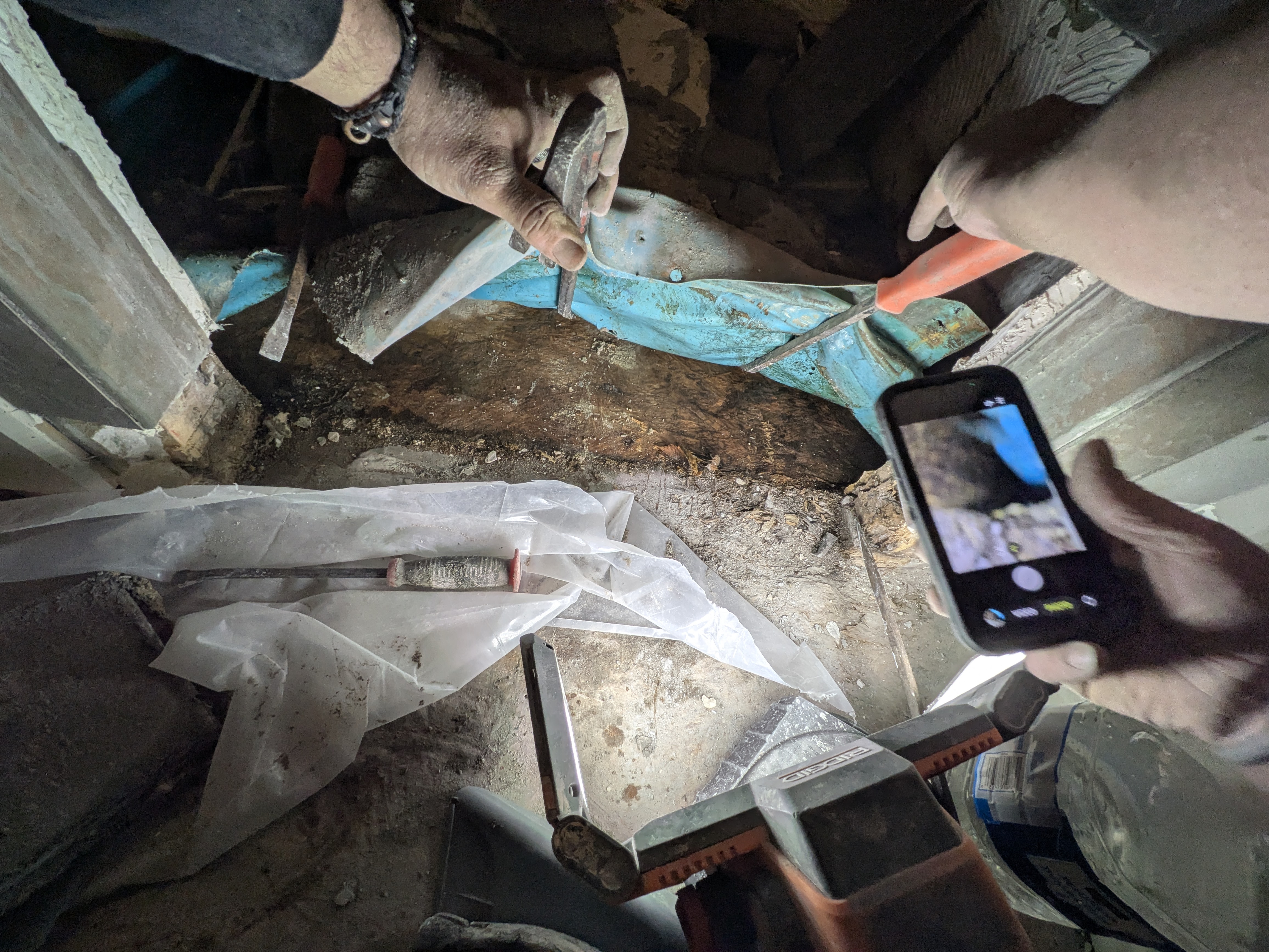 Inspecting bathroom plumbing from the crawl space in Athens GA